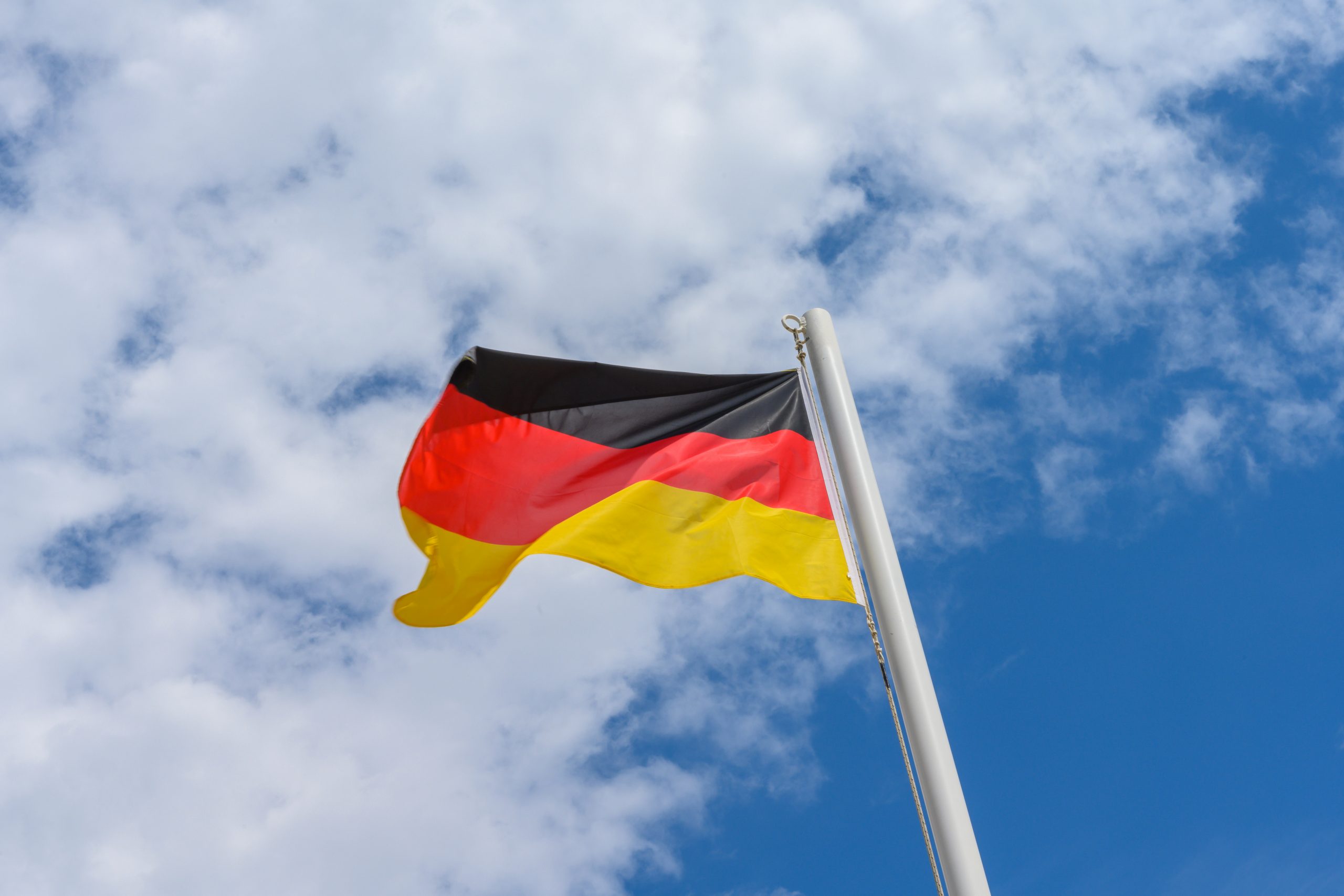 zdjęcie przedstawia niemiecką flagę powiewającą na wietrze